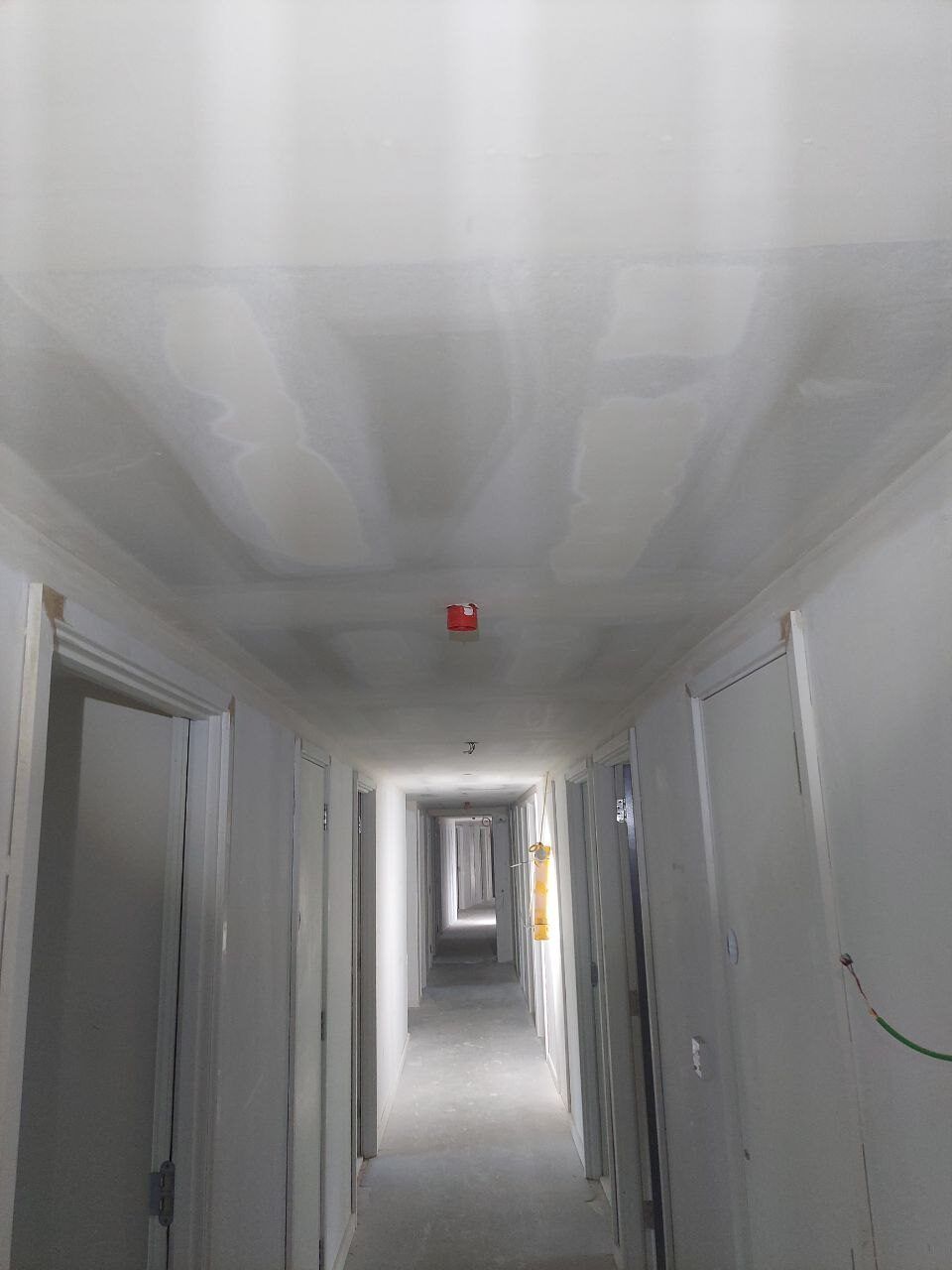 Corridor ceiling with raw plasterboard joints