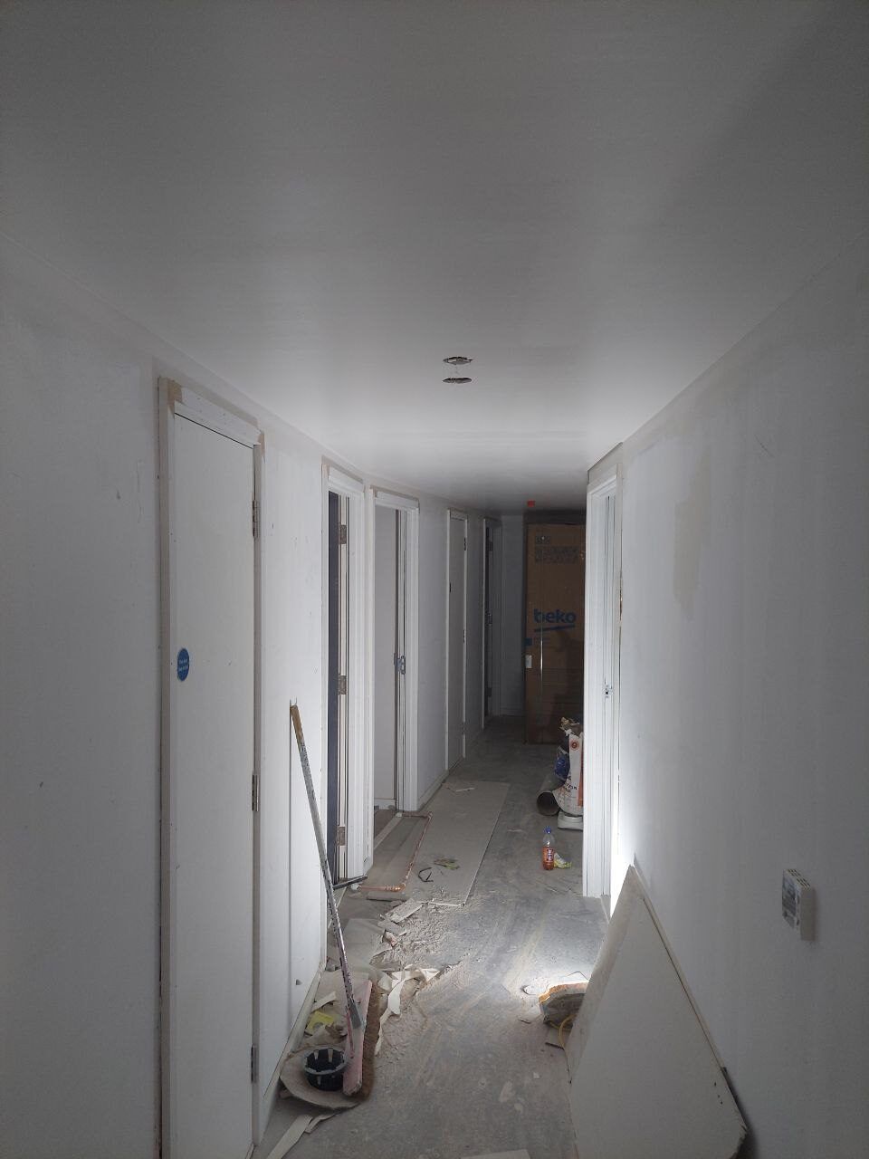 Corridor mid-job with boards and dust sheets