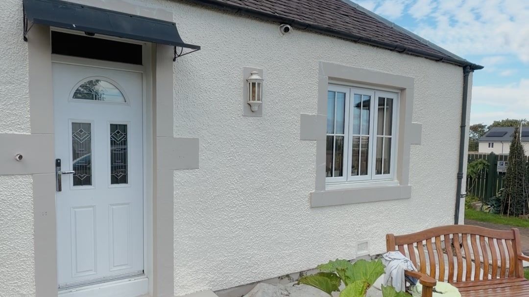 Repainted bungalow front with new door and window