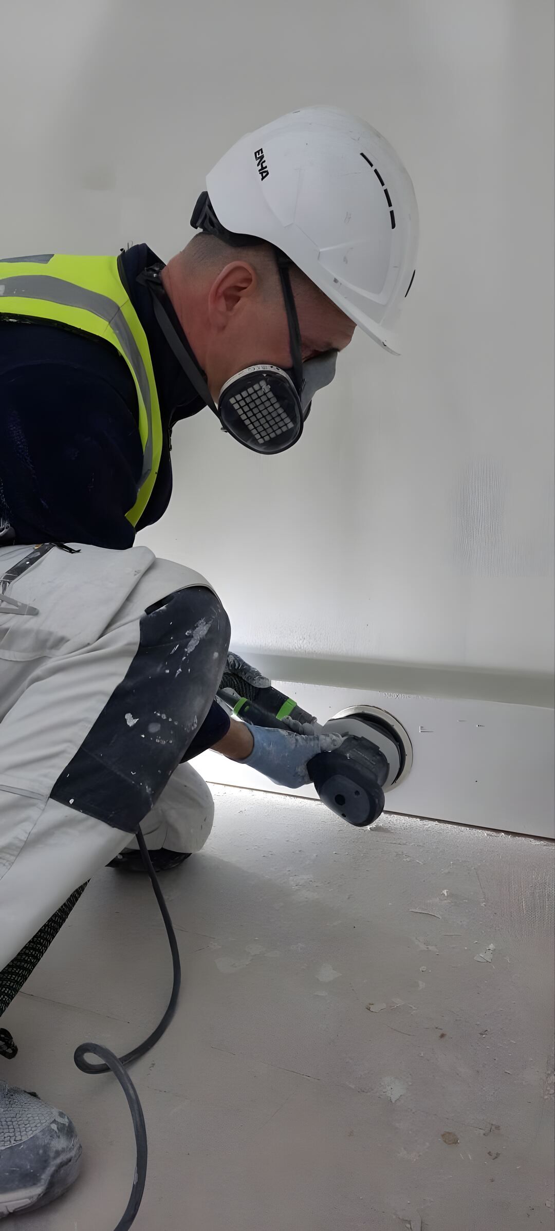 Sanding skirting board on site