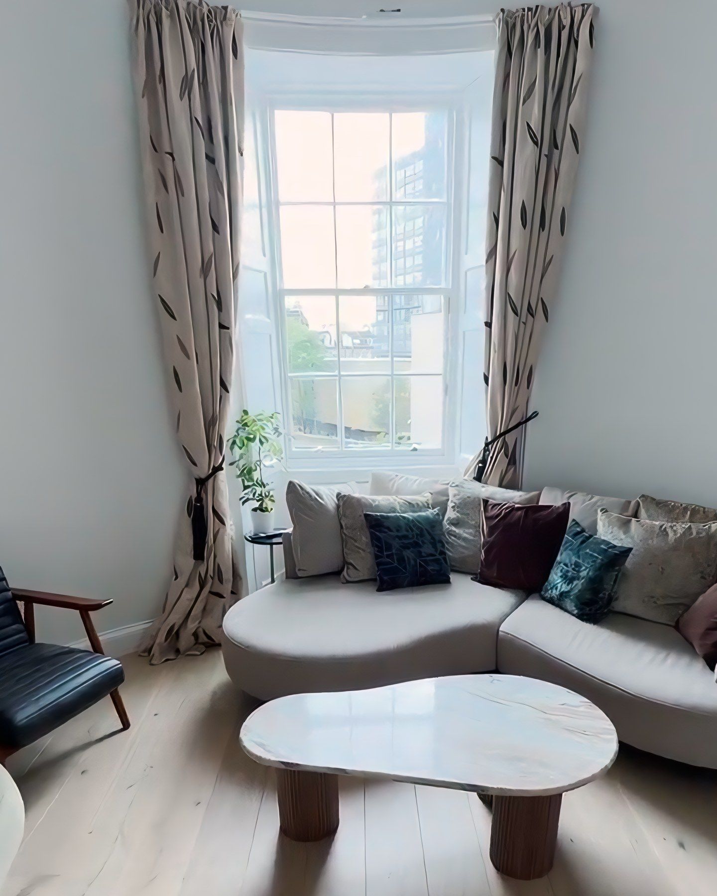 The same bay finished, with oak flooring, curtains and the sofa in place