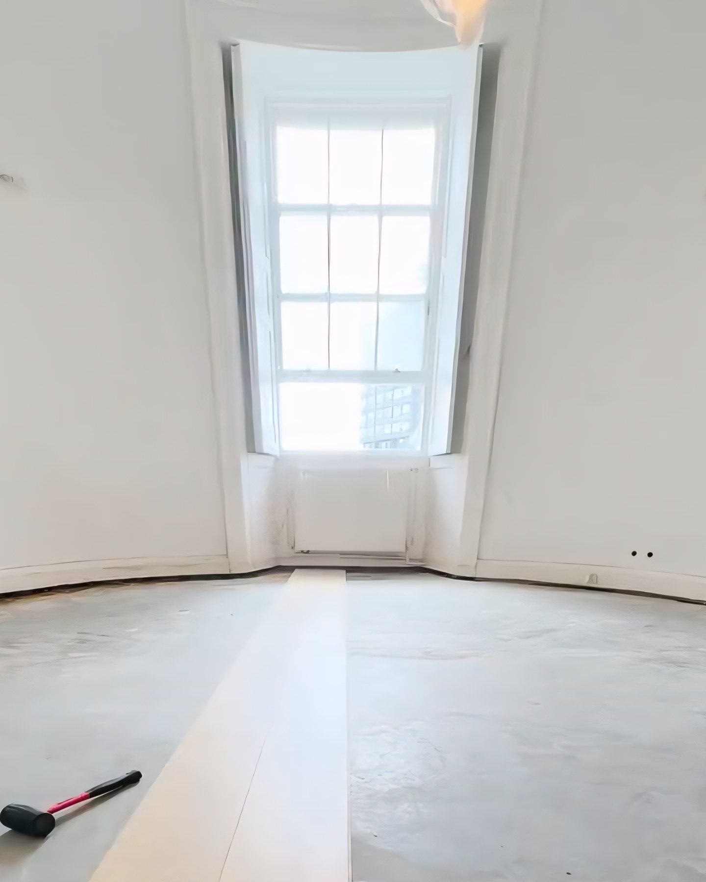 The round living room bay with the floor levelled and the first oak boards going down