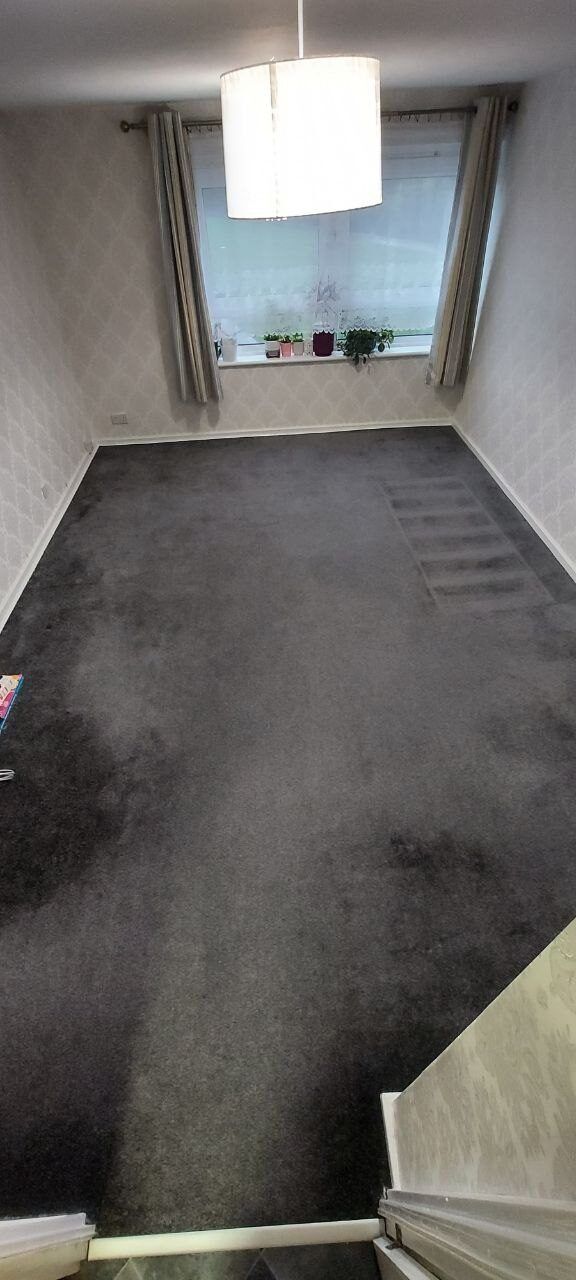 Living room with the old dark carpet, looking towards the window