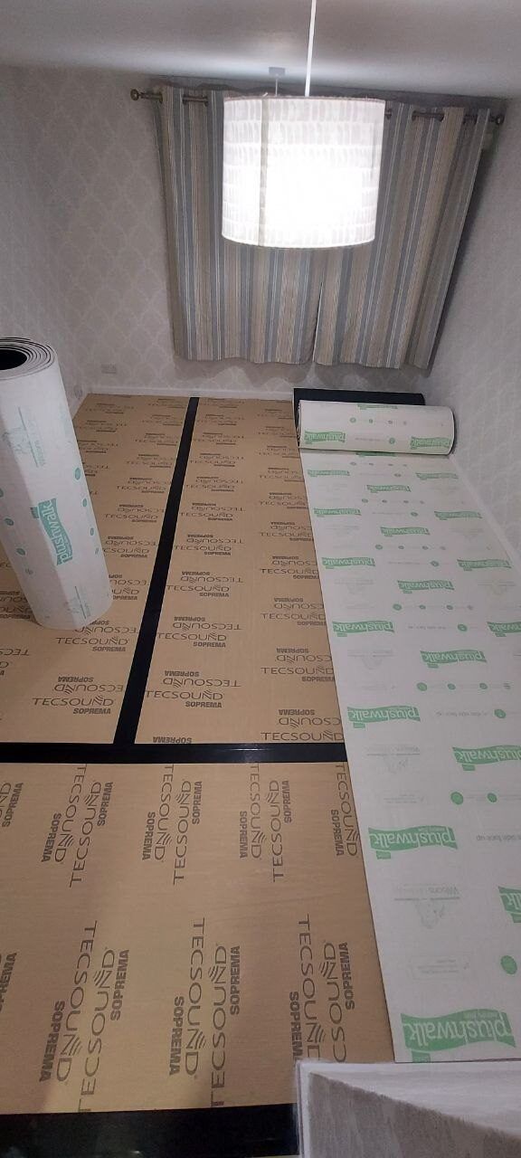 Protective sheet being rolled out over the underlay