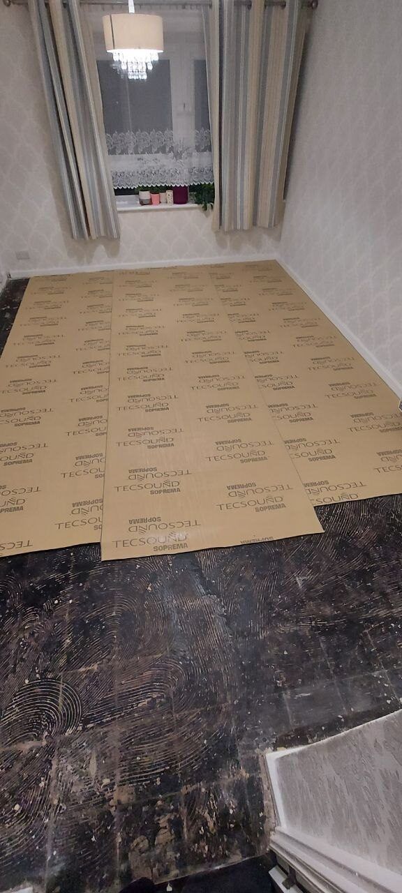 Bare subfloor with the underlay half laid