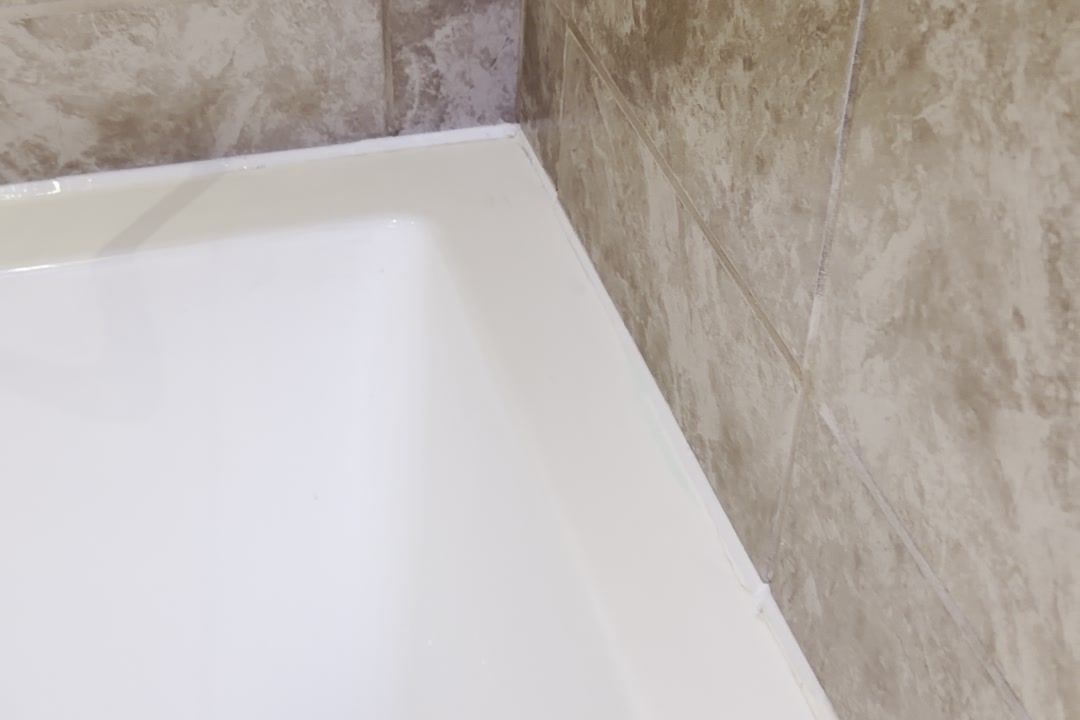 Finished tiles meeting the new bath