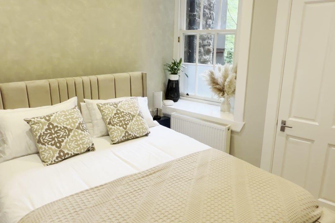 Bedroom with upholstered headboard and fresh paint