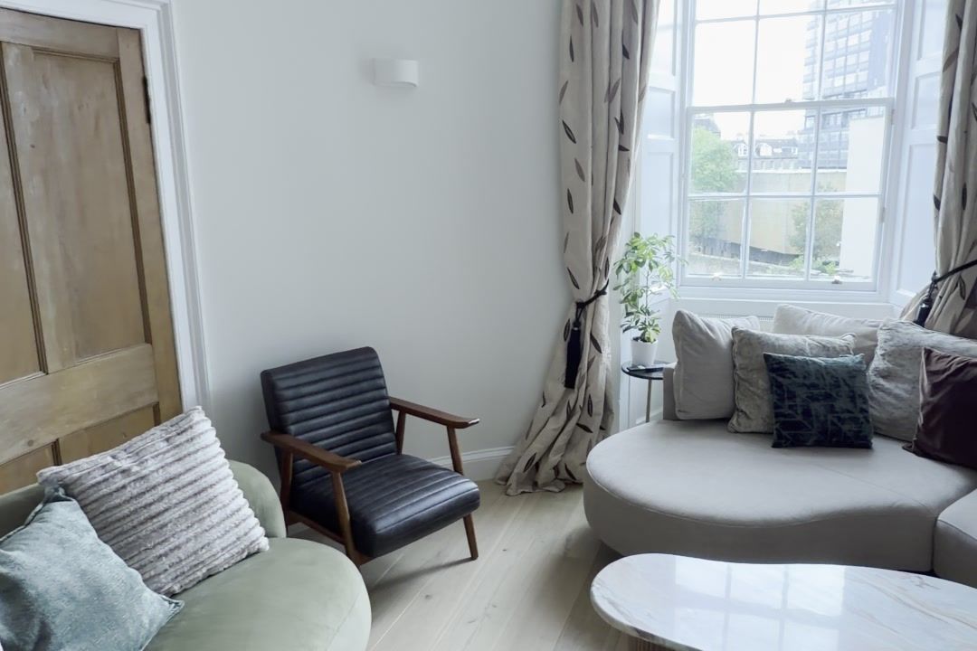 Living room with new oak flooring and curtains